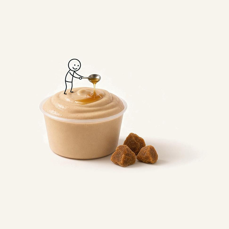 Brown Sugar microwave smoothie in a clear cup, with a figure drizzling brown sugar syrup from a spoon